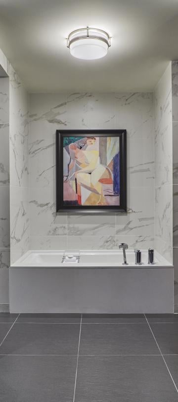 Bathroom with soaking tub, separate shower, enclosed toilet, and a vanity on either side