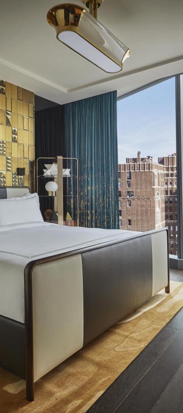 bedroom with king bed and view of the city