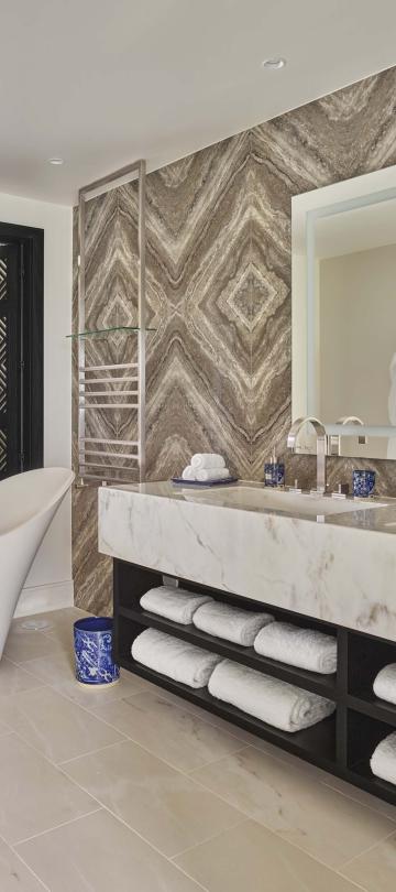 Bathroom with a two sink vanity and a soaking tub