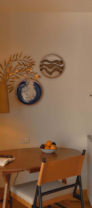Desk in the corner of the room with a standing lamp