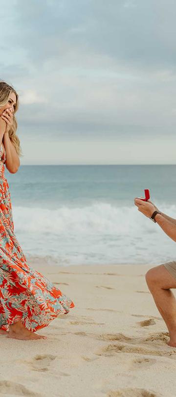 A man proposing to his girlfriend on the beach