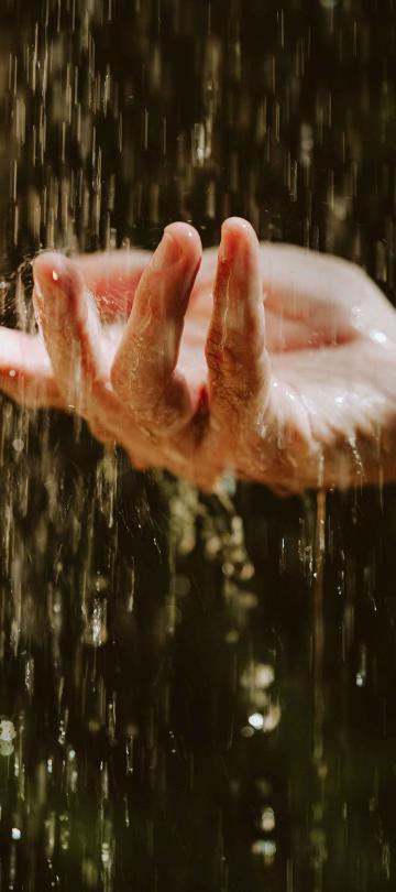 a person holding their hand under water