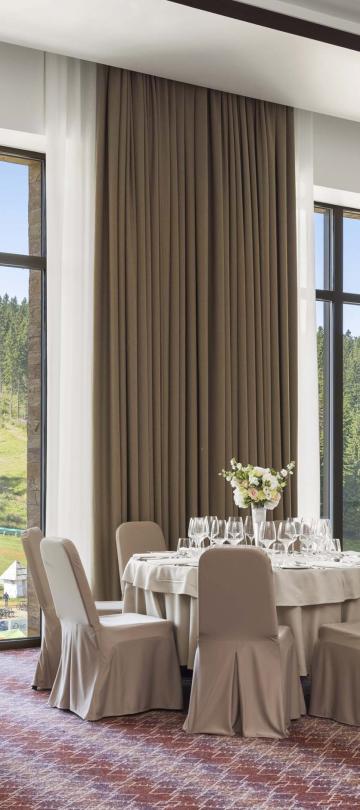 venue with large windows set with round tables