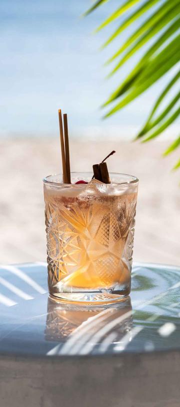 Cocktail sitting on a bench on the beach