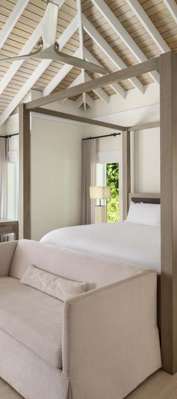 Bedroom with four post bed and couch