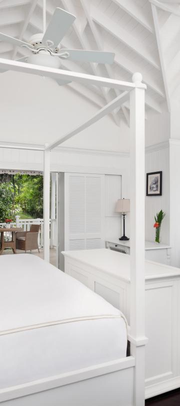 white bedroom with large bed and sitting area