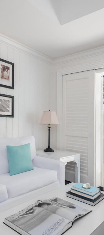living room with white couch and photos hanging on the wall