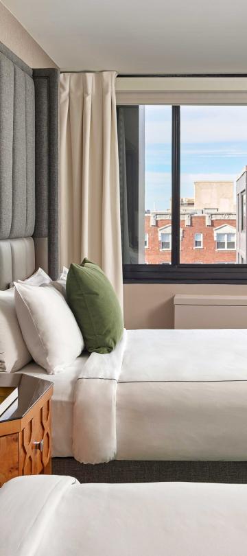 Bedroom with two queen beds and a view of the hotel