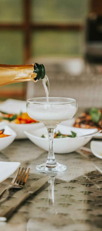 champagne poured into coupe glass