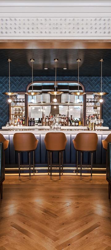 A bar surrounded by dining booths at Somerset