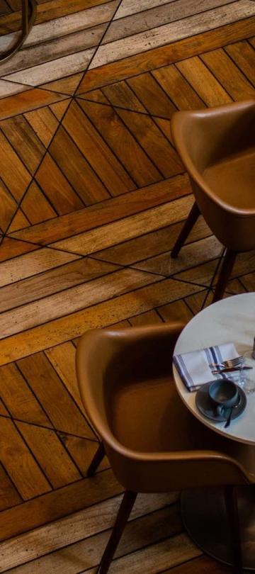 Aerial view of tables on a parquet floor at Somerset restaurant, at Viceroy Chicago