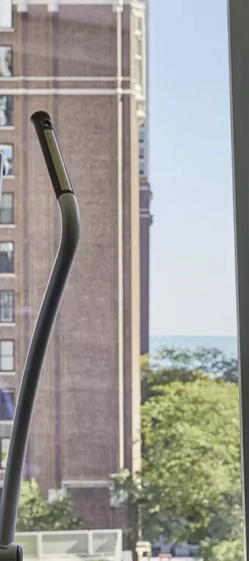 Two workout machines in front of a window at Viceroy Chiago