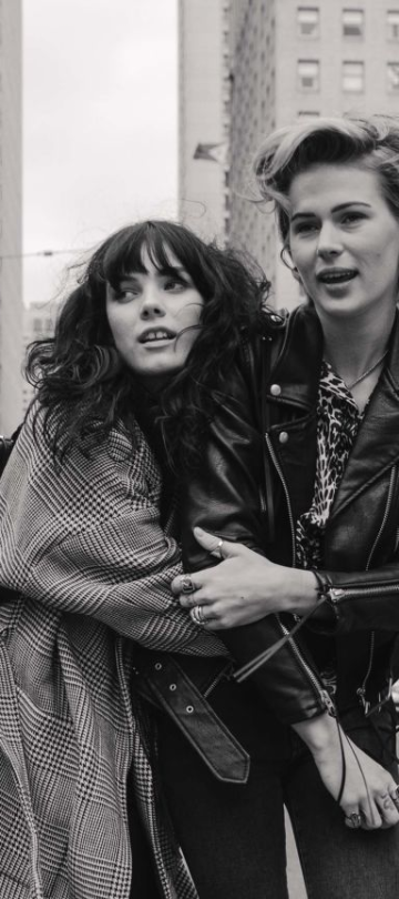 LGBTQ friends walk down the road in an urban setting