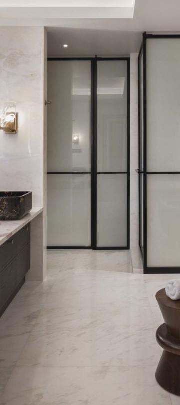 A washroom with a large double sink marble vanity and a soaker tub in a penthouse suite at Viceroy Kopaonik Serbia
