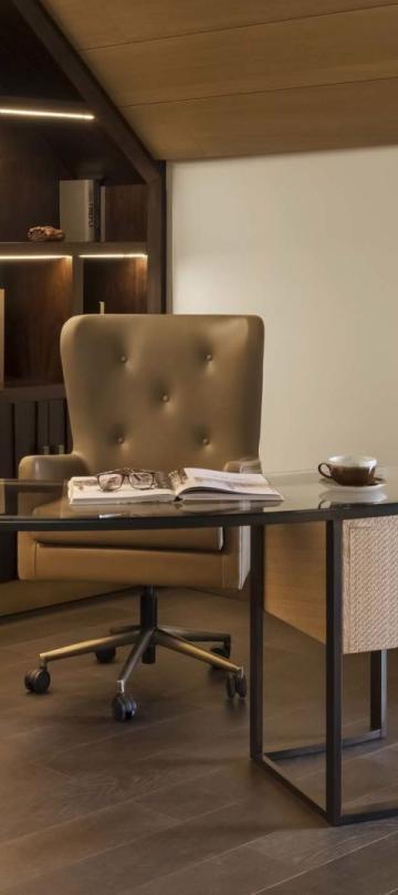 A desk area in a penthouse suite with an in wall fireplace A washroom with a large double sink vanity and a soaker tub in a penthouse suite at Viceroy Kopaonik Serbia