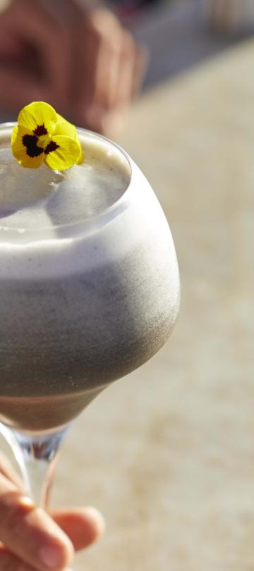 An elegant cocktail is placed on a bar at Cielomar