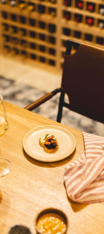 A dish and wine glass in the Wine Bar at Los Cabos