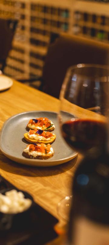 A dish and wine glass in the Wine Bar at Los Cabos