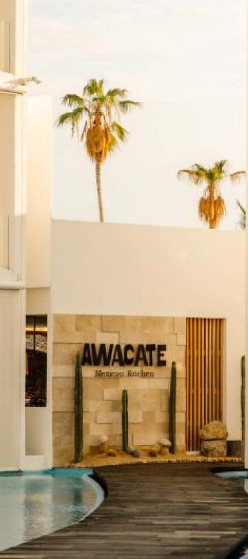 The exterior of Awacate restaurant at Viceroy Los Cabos, at the end of a pathway between two ponds