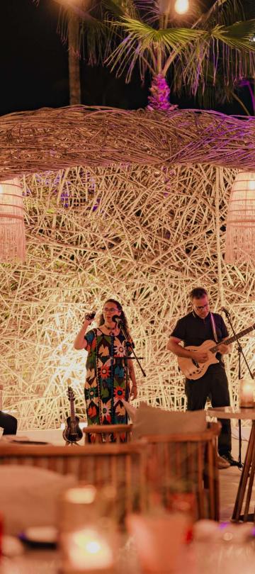 A band performing music to patron at Awacate at Los Cabos