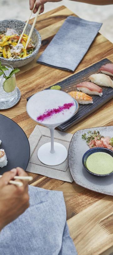 An overview of a couple eating assorted sushi at Nido