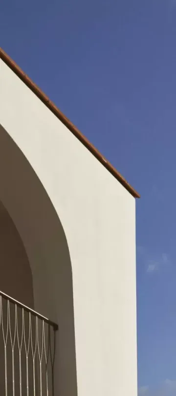 A balcony looking out on a bright blue sky