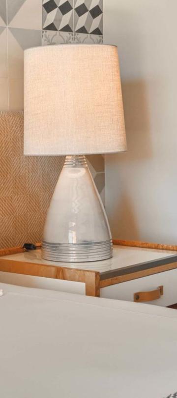 The corner of a bed and the night stand in a deluxe king room at Viceroy Ombria Algarve