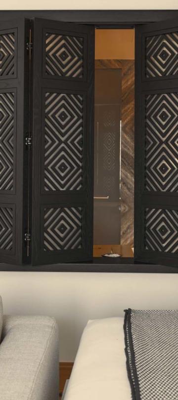 The side of a bed in a deluxe king room at Viceroy Ombria Algarve