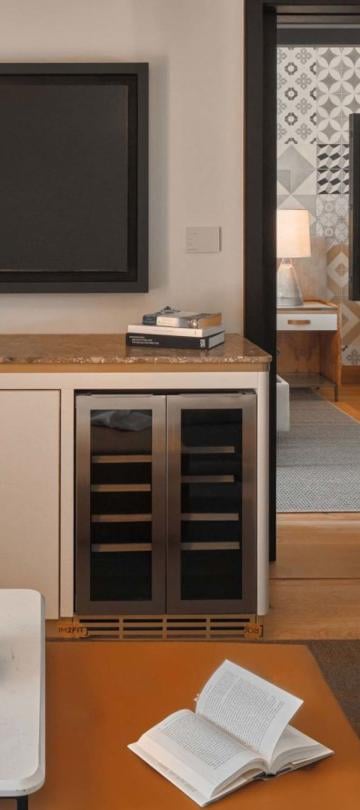 A coffee table, credenza with a tv on top in a one bedroom suite at Viceroy Ombria Algarve