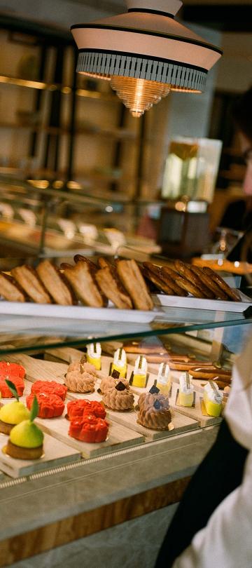 A woman looks at the assortment of pastries at Cafe Central