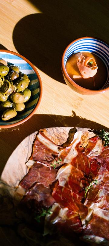 An assortment of olives and cured meats from Ombria Kitchen