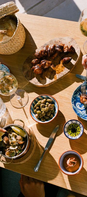 An assortment of dishes and wines on a table at Ombria Kitchen
