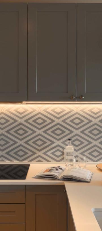 A kitchen area with sink, cook top and warm lighting in a residence at Viceroy Ombris Algarve
