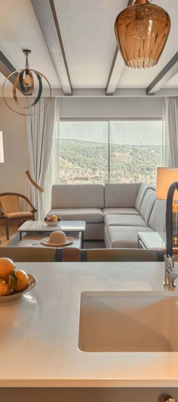 A kitchette looking into an open living room in a residence at Viceroy Ombris Algarve