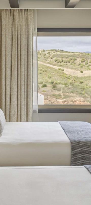 Two beds in a warm bedroom in two bedroom residence at Viceroy Ombria Algarve