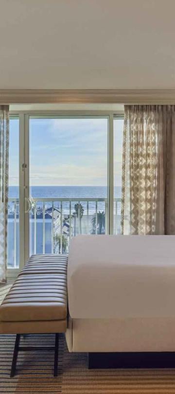 A king bed and balcony in a Junior Suite at Viceroy Santa Monica