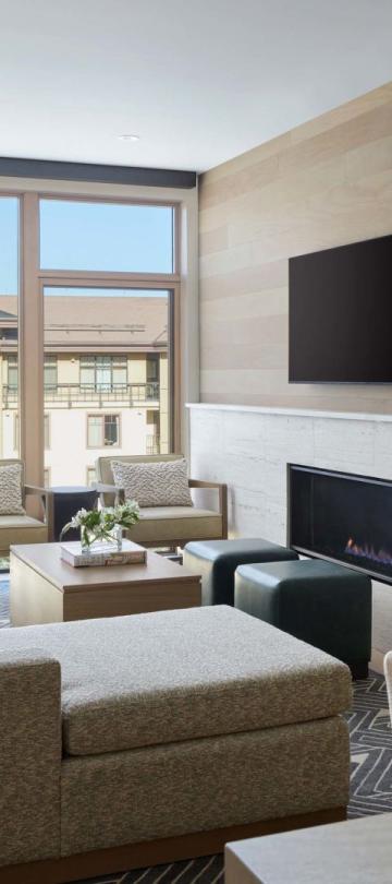 A well-appointed living room with a fireplace and a wall-mounted TV