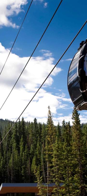 Ski lift cars ascending the mountain on a Summer day