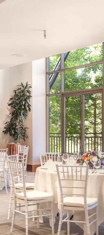 A bright banquet room with tables at Viceroy Snowmass