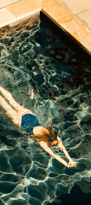 A woman swimming in a pool at Viceroy Snowmass