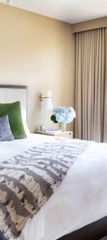 A king bed in a Pinnacle Three Bedroom Residential Suite at viceroy Snowmass