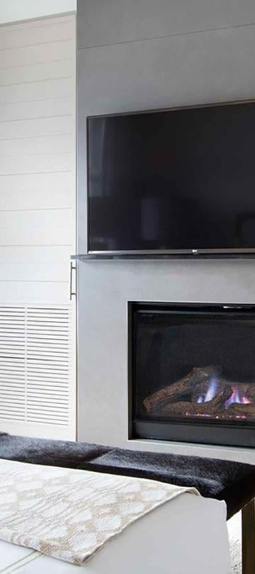 The fireplace and TV in a Pinnacle Two Bedroom Premium Residence at Viceroy Snowmass