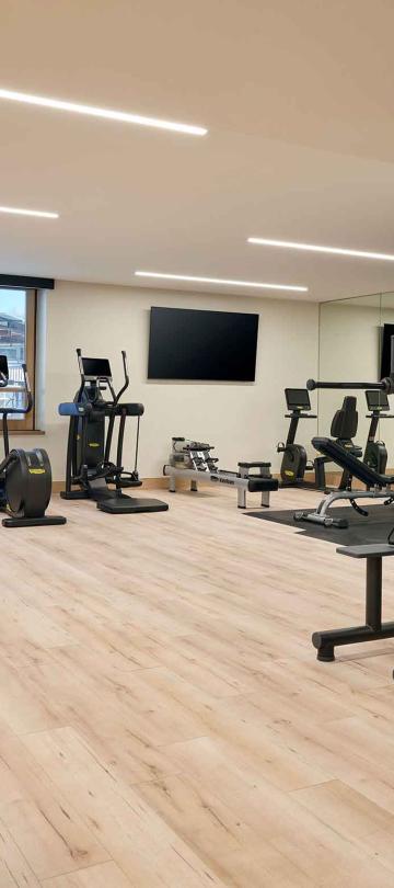 The fitness center at Viceroy Snowmass, with treadmills, exercise bikes and a workout mat