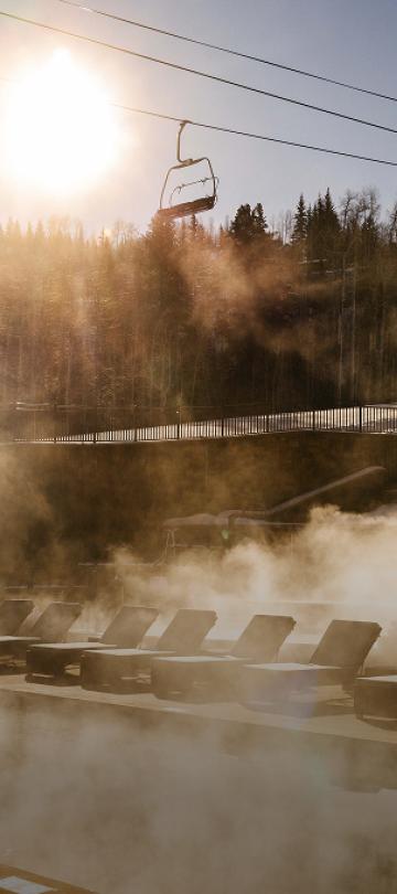 Steam rising from a spa pool, in view of the ski hill at Viceroy Snowmass