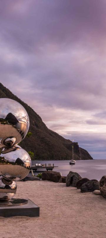 A sculpture consisting of three metallic balls, at the foot of the Pitons in Saint Lucia
