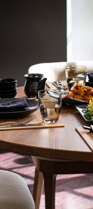 A dining table with dishes set up on it at  The Cane Bar