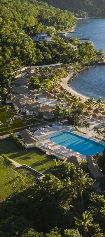 Overhead view of Viceroy Sugar Beach property with the ocean, pools, and green areas