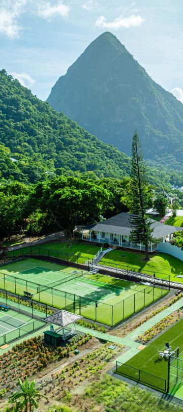 Three racquet courts and a view of the beautiful mountains at Viceroy Sugar Beach