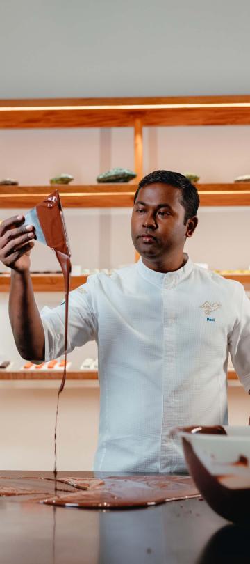A chocolatier mixes chocolate