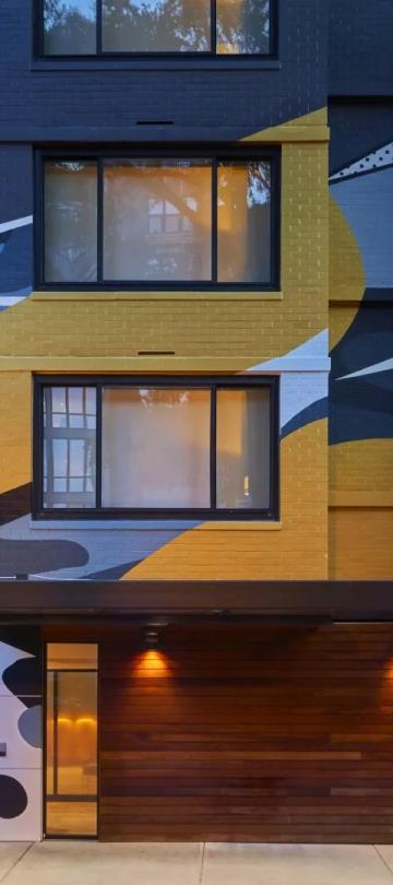 The exterior of Viceroy Washington DC, with an elaborate grey and yellow graffiti-style mural